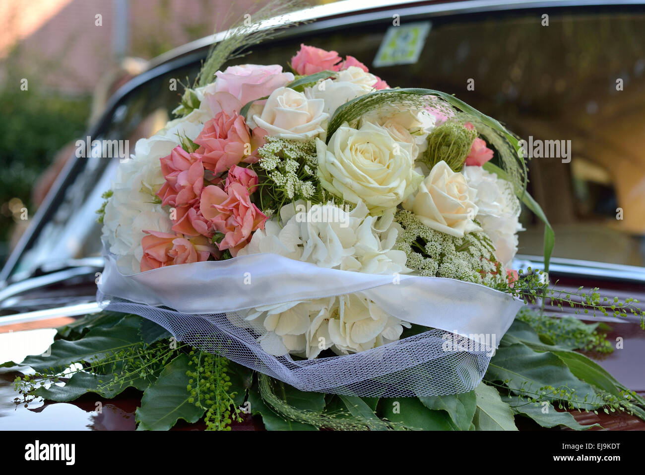 Rose bouquet on wedding car Stock Photo