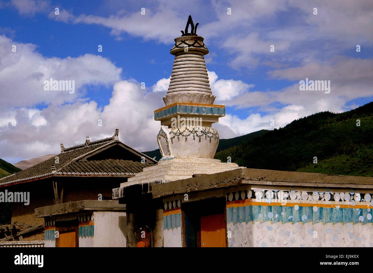 Gamel, China:  A white ornate ringed Dagoba sits above a funery oven at the Gamel Chador Gonchen Tibetan Temple Stock Photo