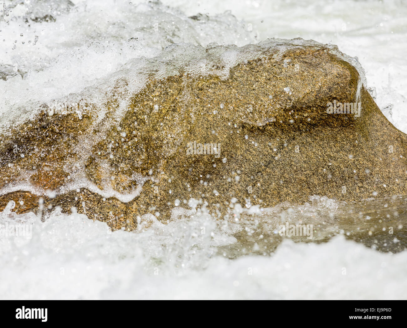 Sharp simple shot of water over rock Stock Photo