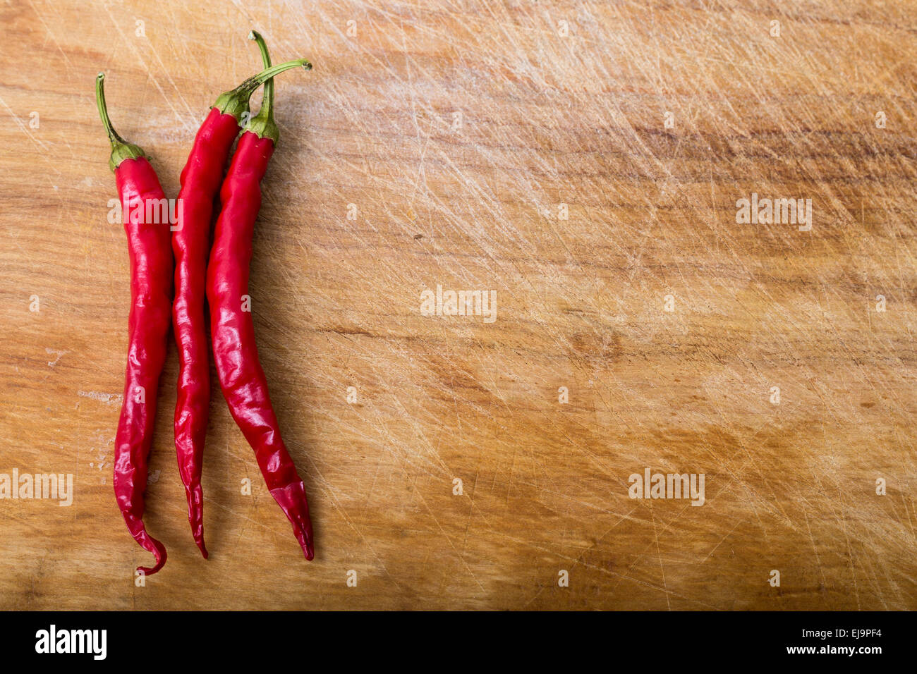 chili peppers on cutting board Stock Photo
