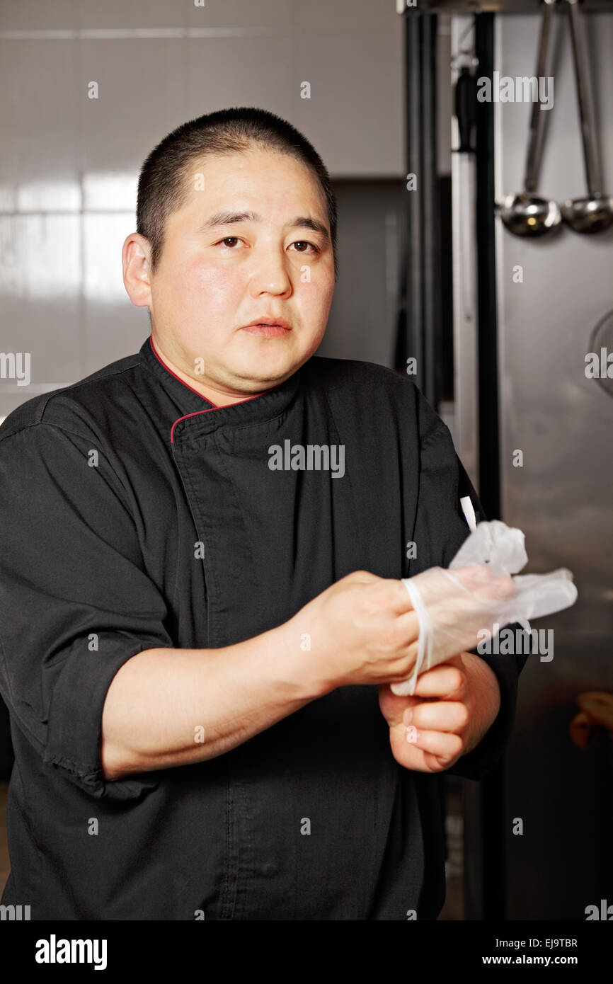 Chef wearing on gloves Stock Photo Alamy