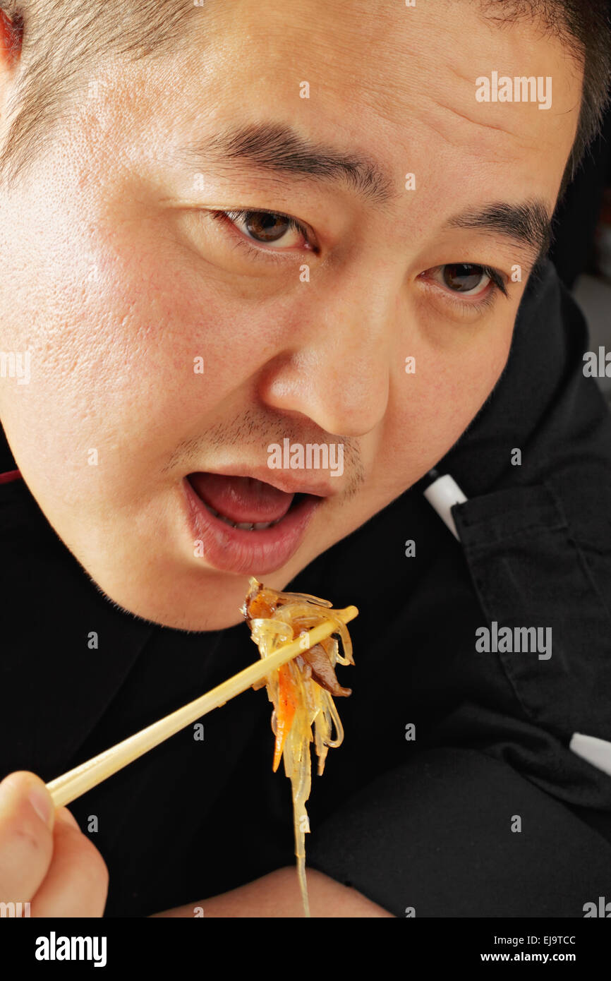 Guy eating glass noodles Stock Photo