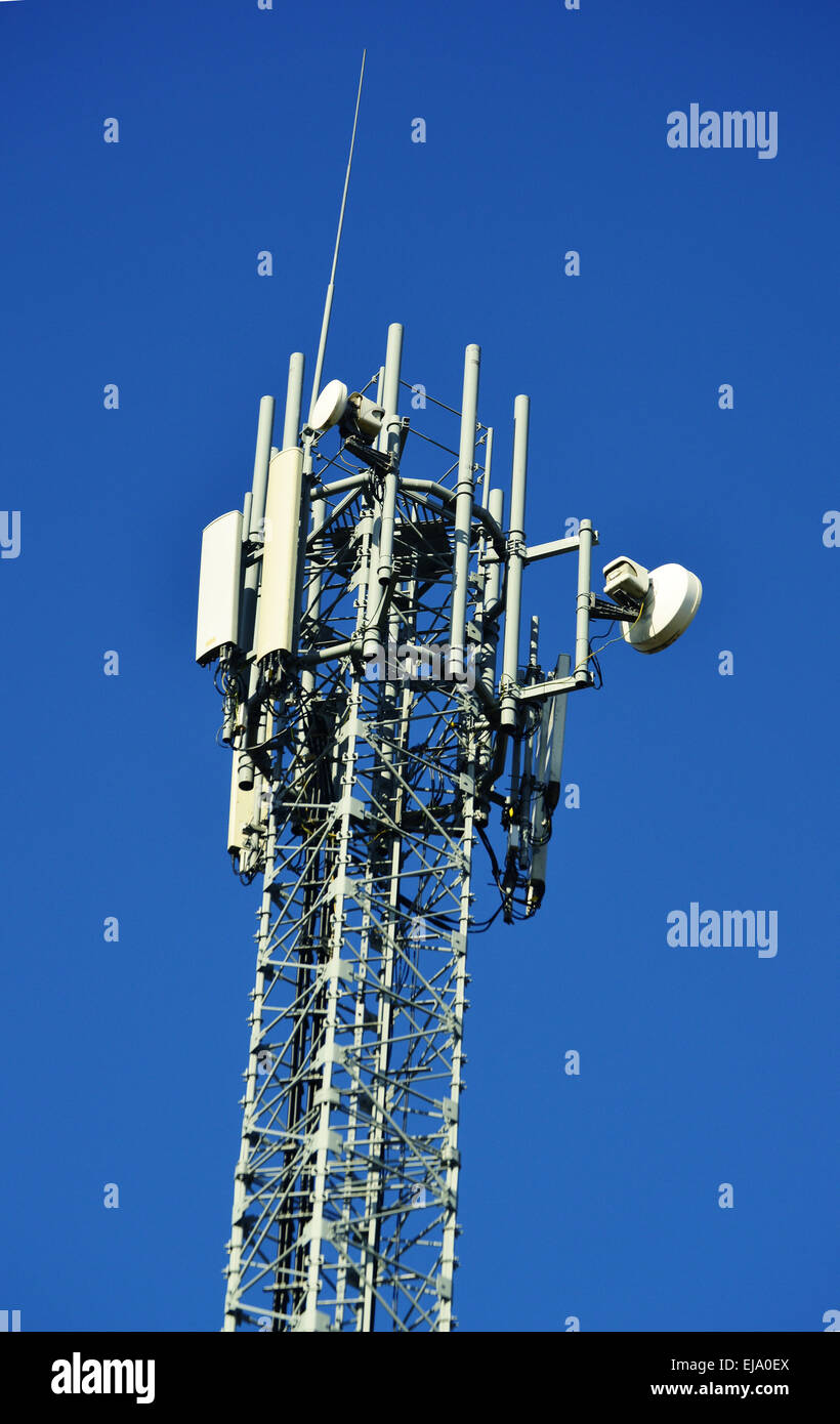 Cell phone tower over blue sky. Stock Photo