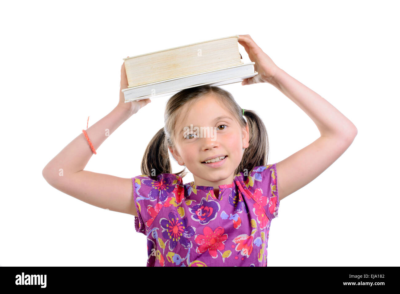 schoolgirl with books on her head on white background Stock Photo - Alamy