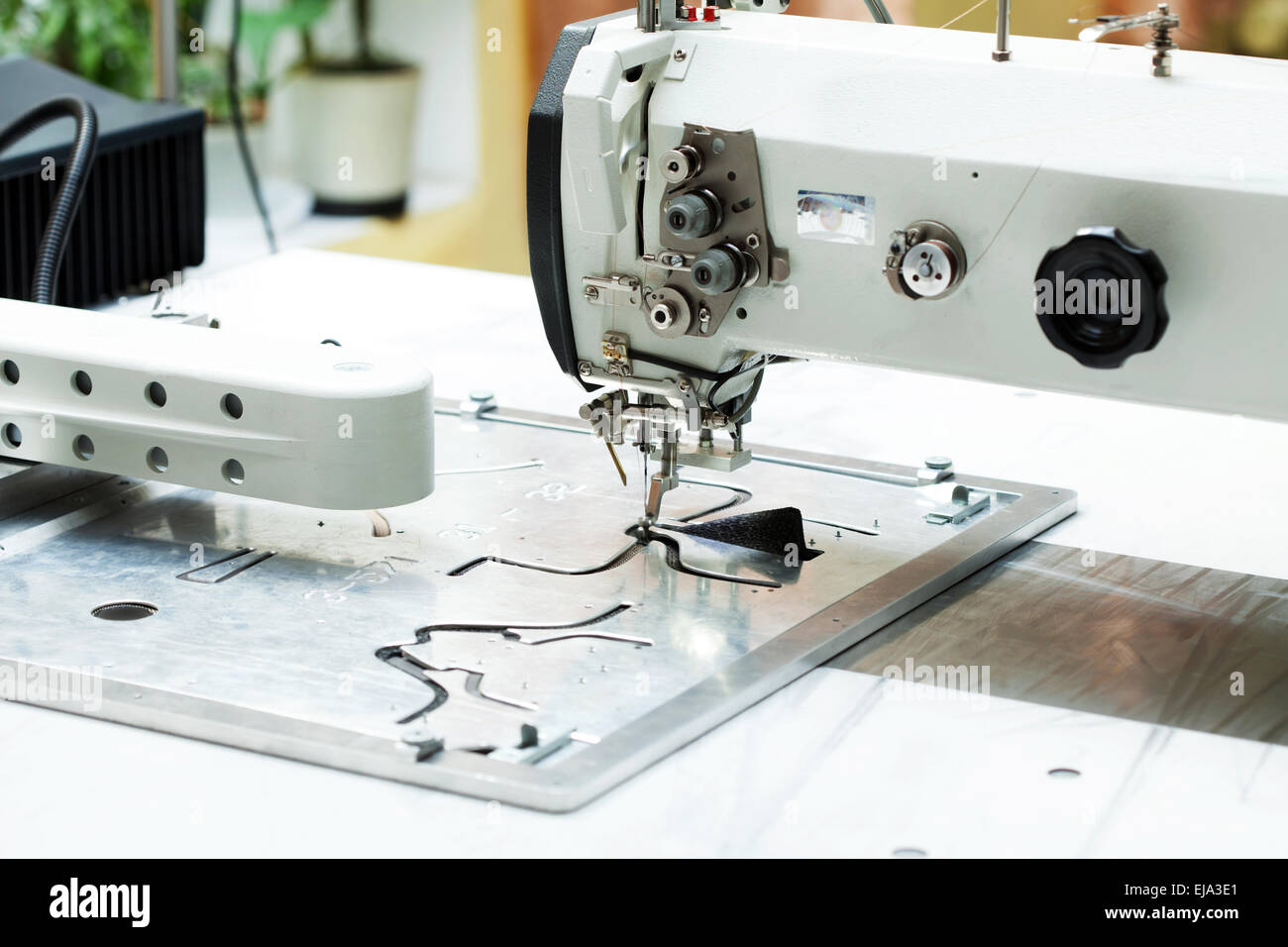 Machine sews parts of shoes, closeup Stock Photo Alamy