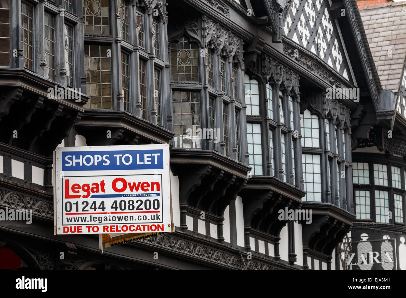 Shops To let sign on commercial property -  half-timbered shops  in the historic centre of Chester. Stock Photo