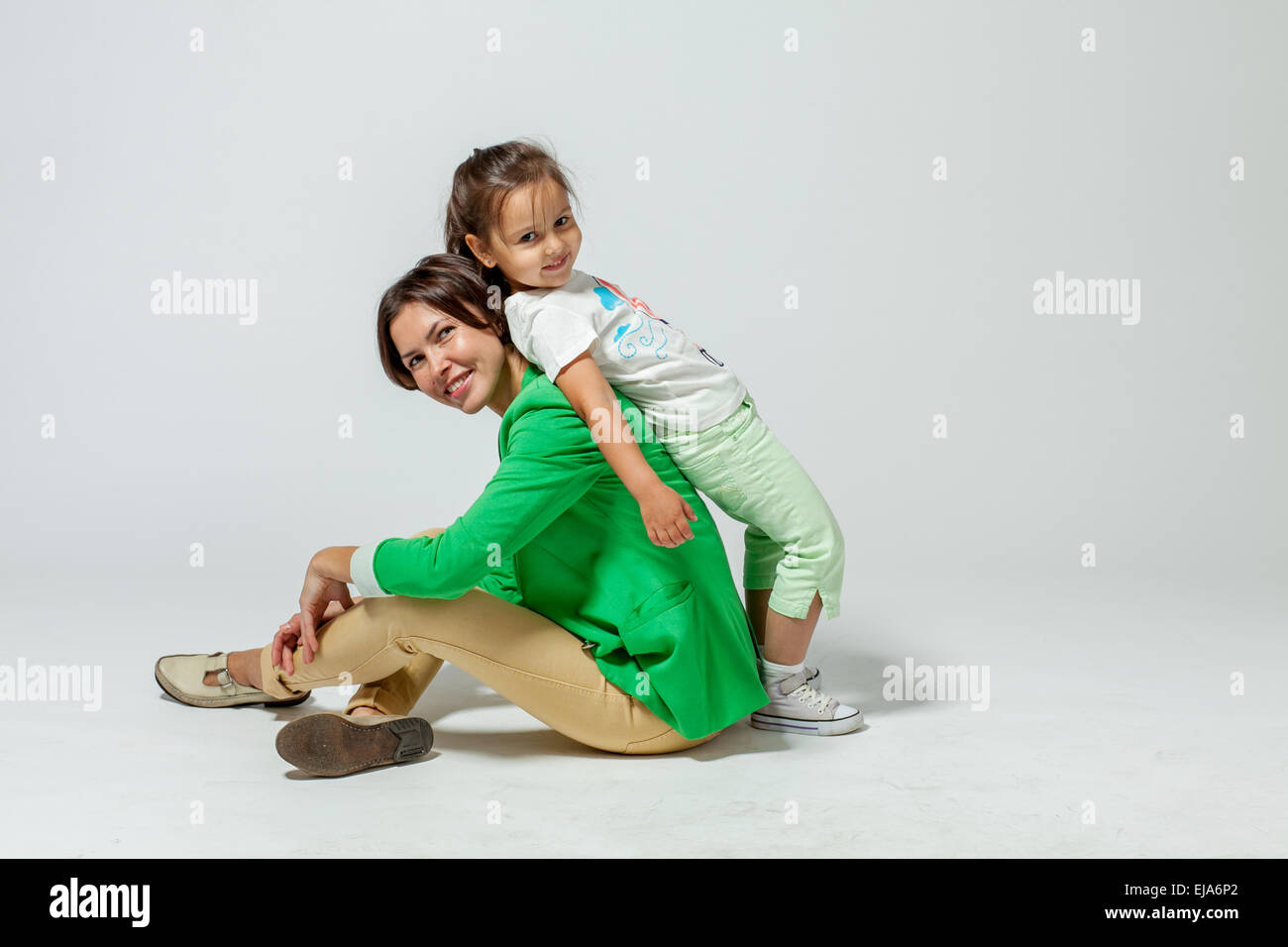 daughter leaning on mom Stock Photo