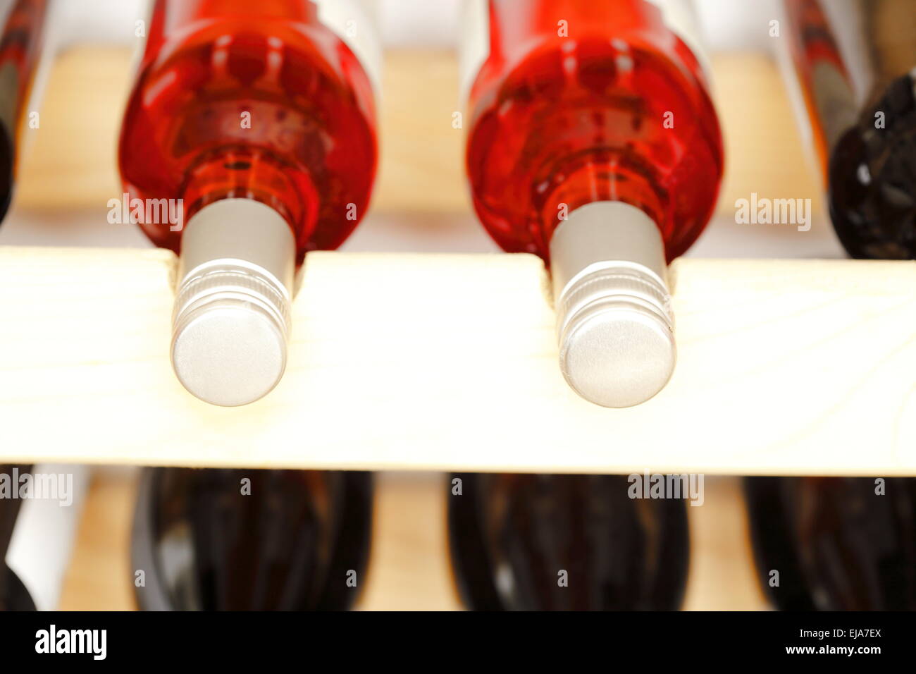 wine bottles in wooden stack Stock Photo