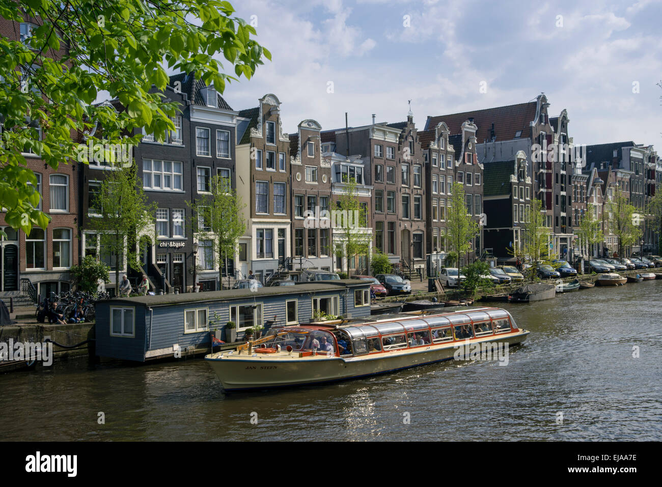 Canal with buildings and houseboats in Amsterdam Stock Photo