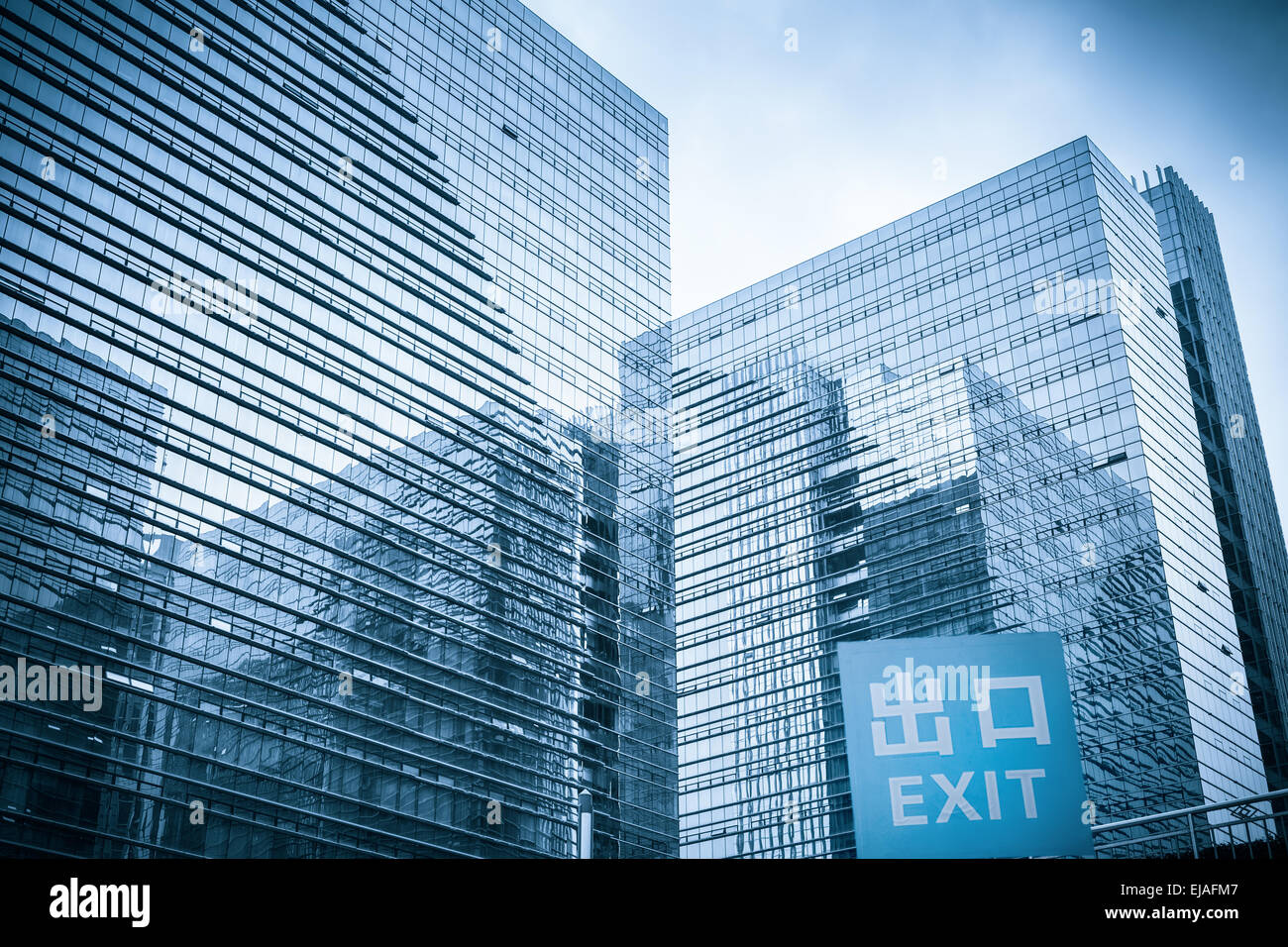 modern glass skyscraper with garage exit traffic sign Stock Photo