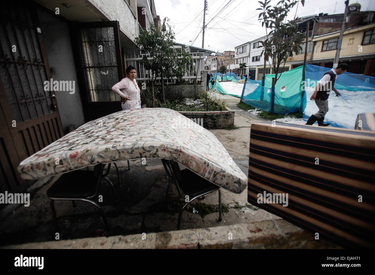 Bogota, Colombia. 23rd Mar, 2015. Residents watch their belongings ...