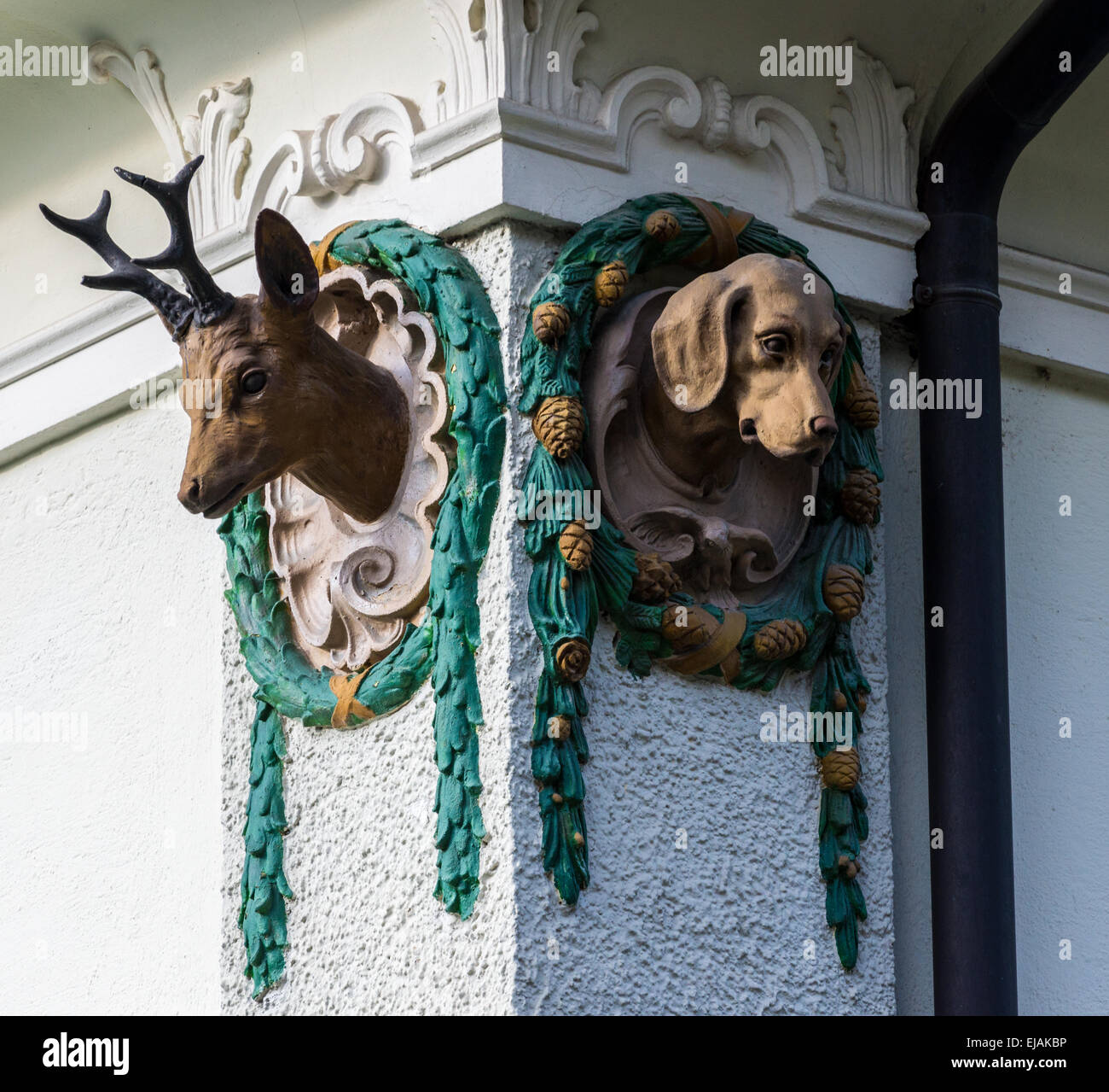 Deer and Dog Outdoor Wall Ornament in Hohenschwangau, Germany Stock Photo