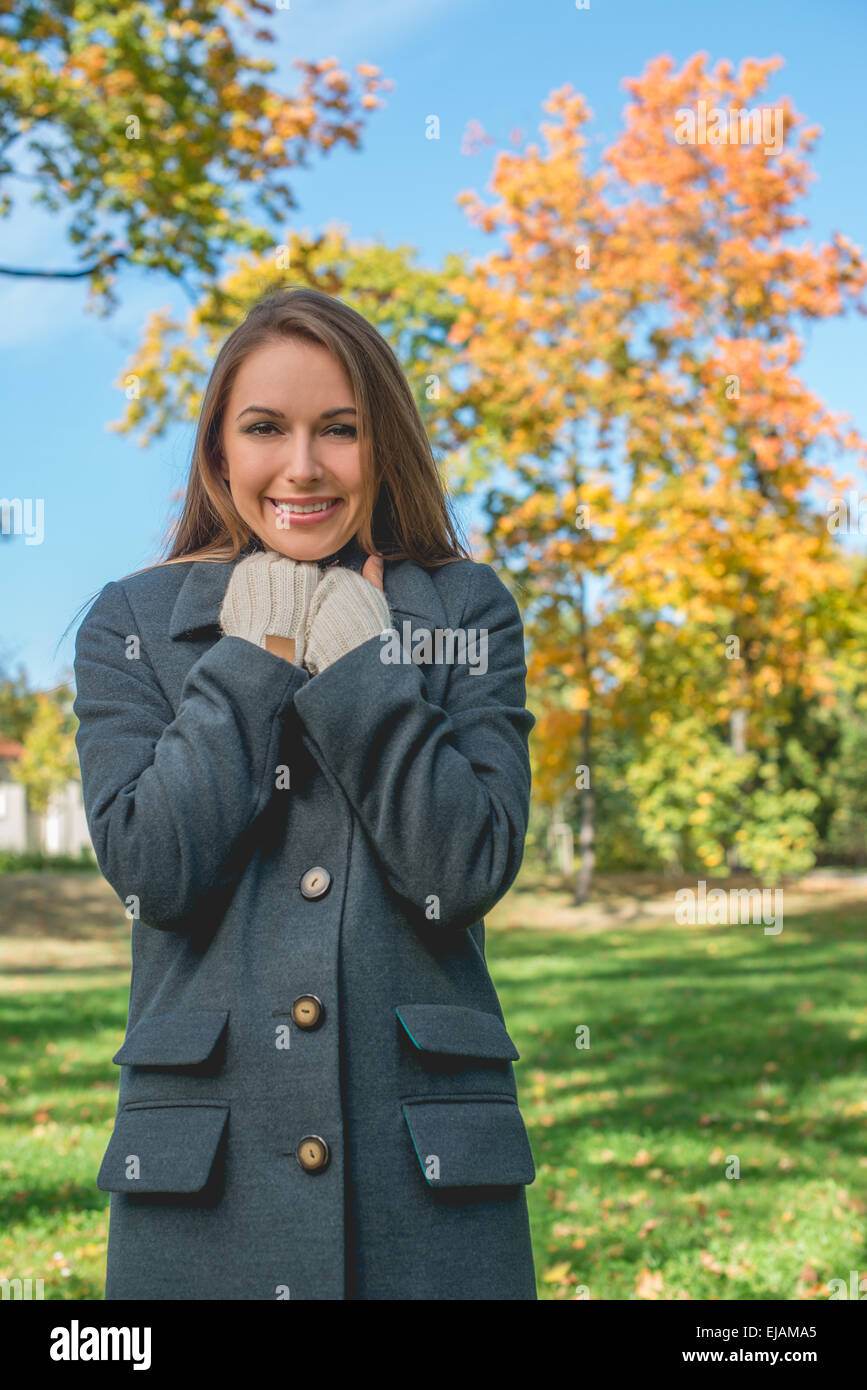 Smiling Pretty Woman Chilling in Gray Coat Stock Photo