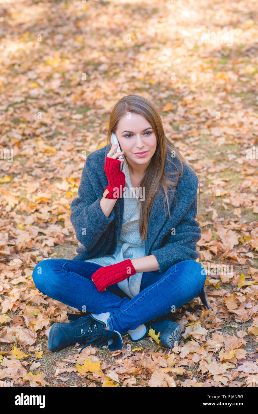 Young woman chatting on her mobile Stock Photo