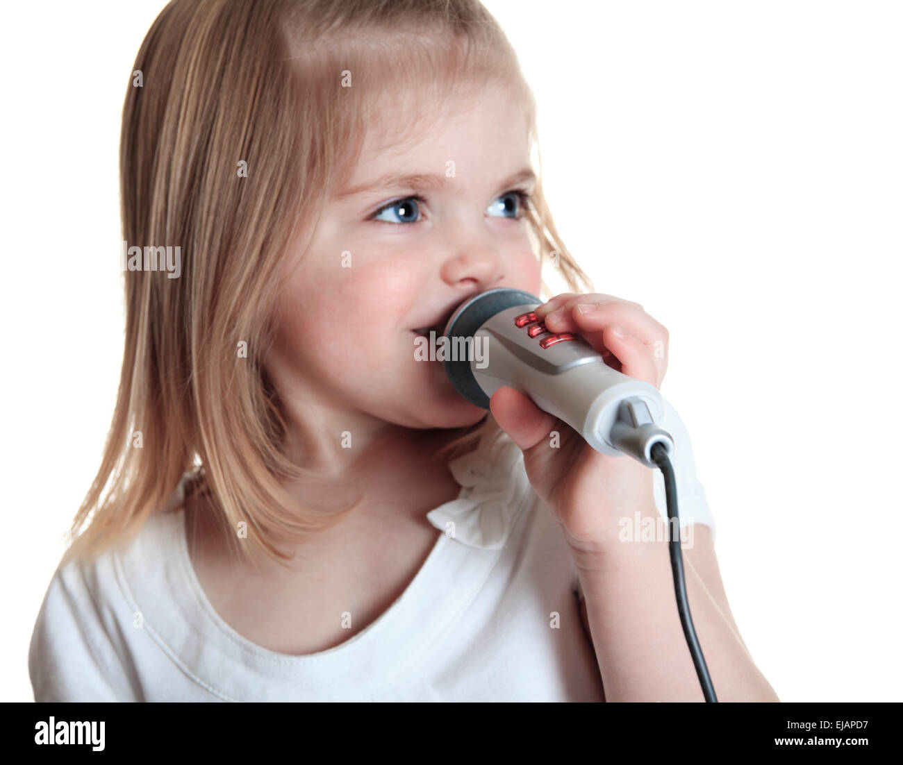 Funny little girl singing with a microphone Stock Photo Alamy