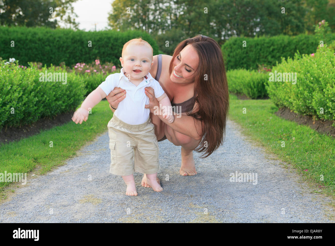 Baby blond boy walking mother hi-res stock photography and images - Alamy
