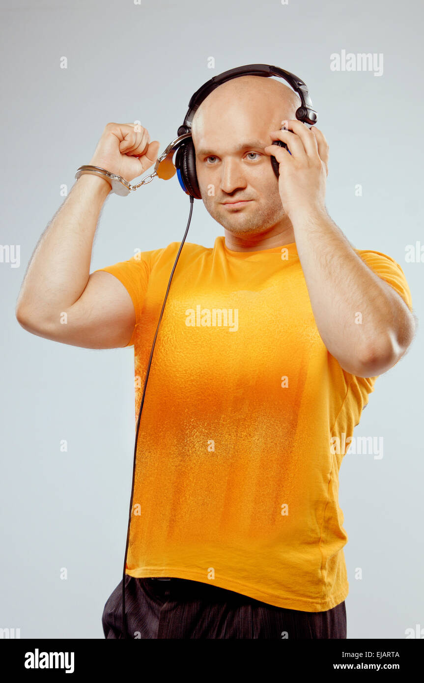 DJ with headphones and handcuffs Stock Photo Alamy