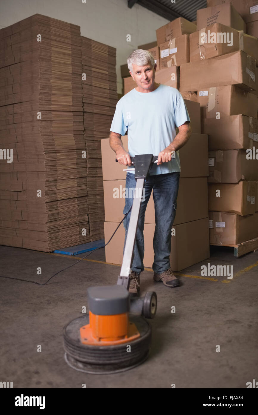 Man cleaning warehouse floor with machine Stock Photo Alamy