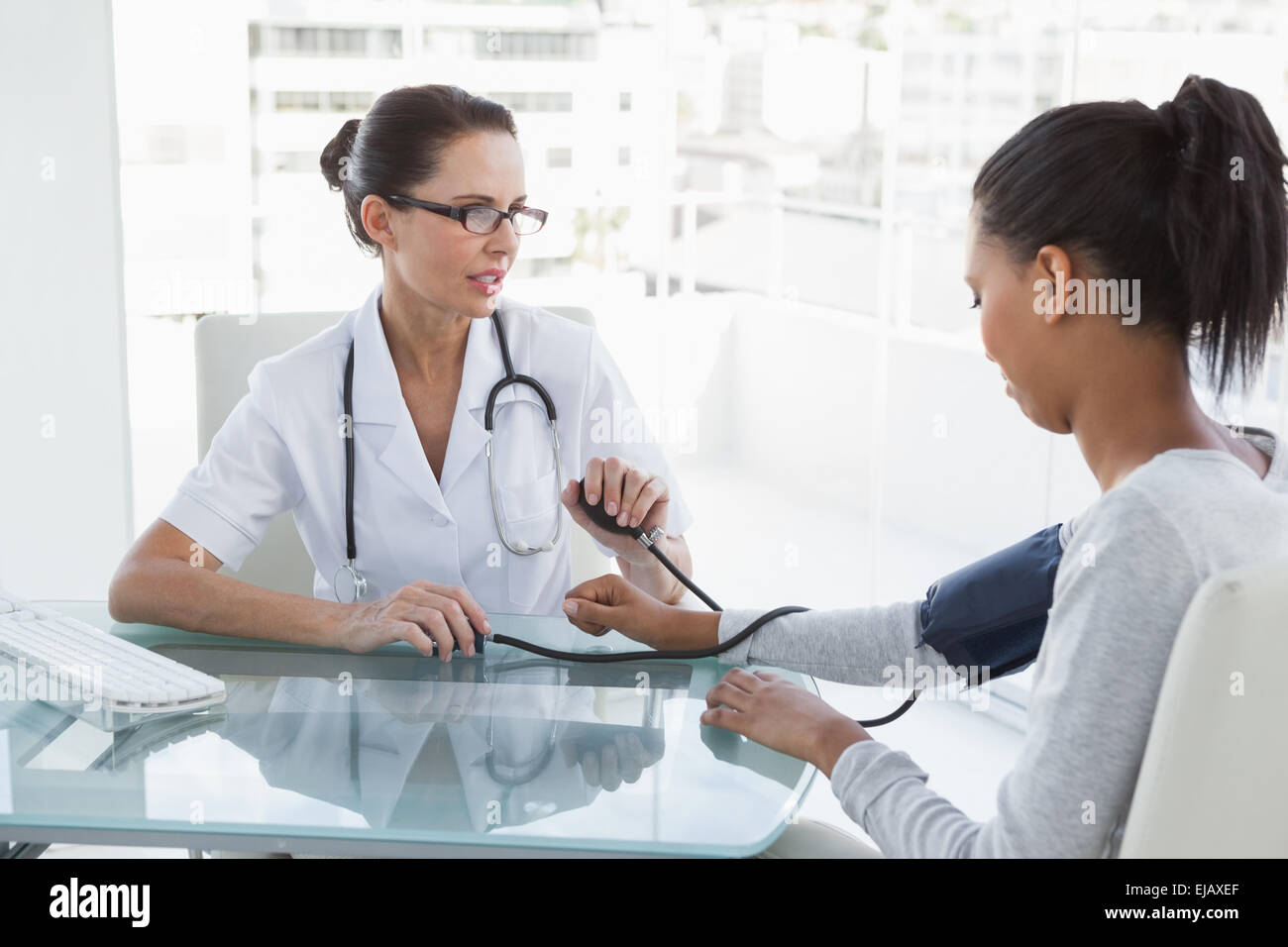 Doctor taking patients blood pressure Stock Photo - Alamy