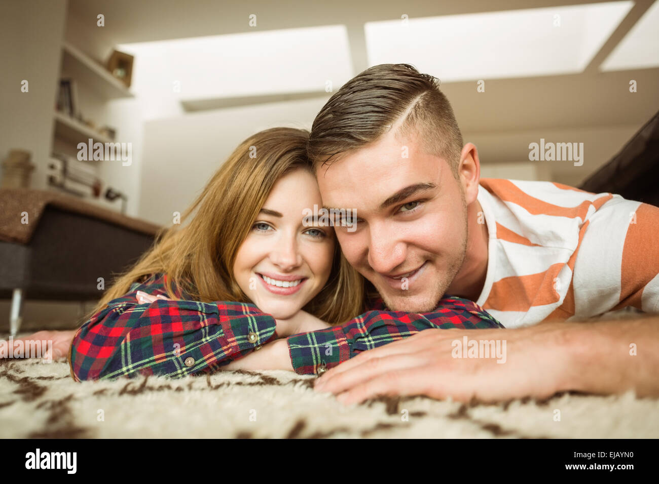 Cute couple smiling at camera Stock Photo - Alamy