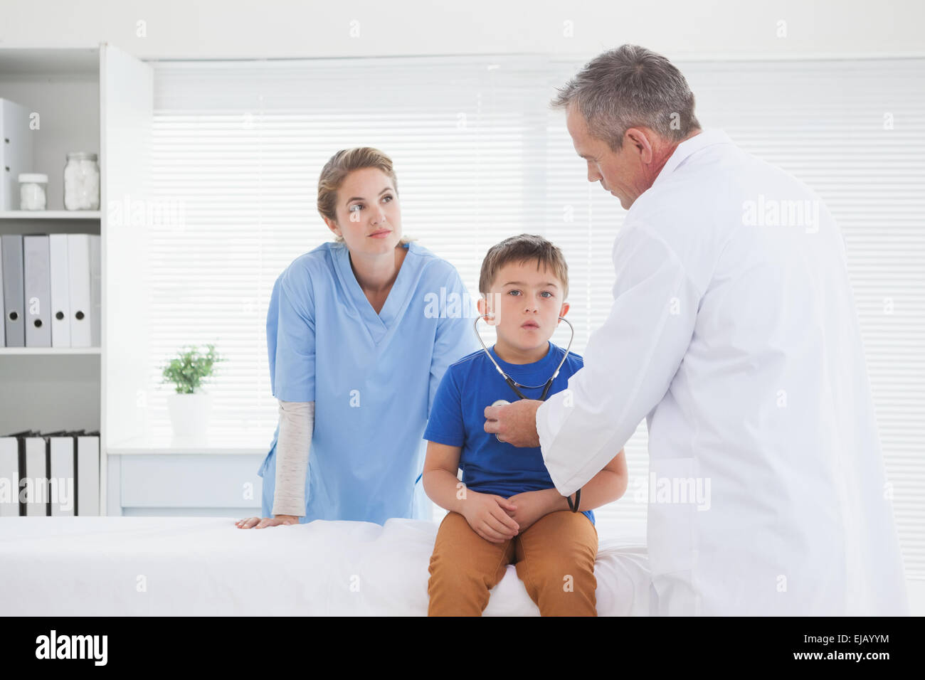 Doctor letting a patient hear his heartbeat Stock Photo