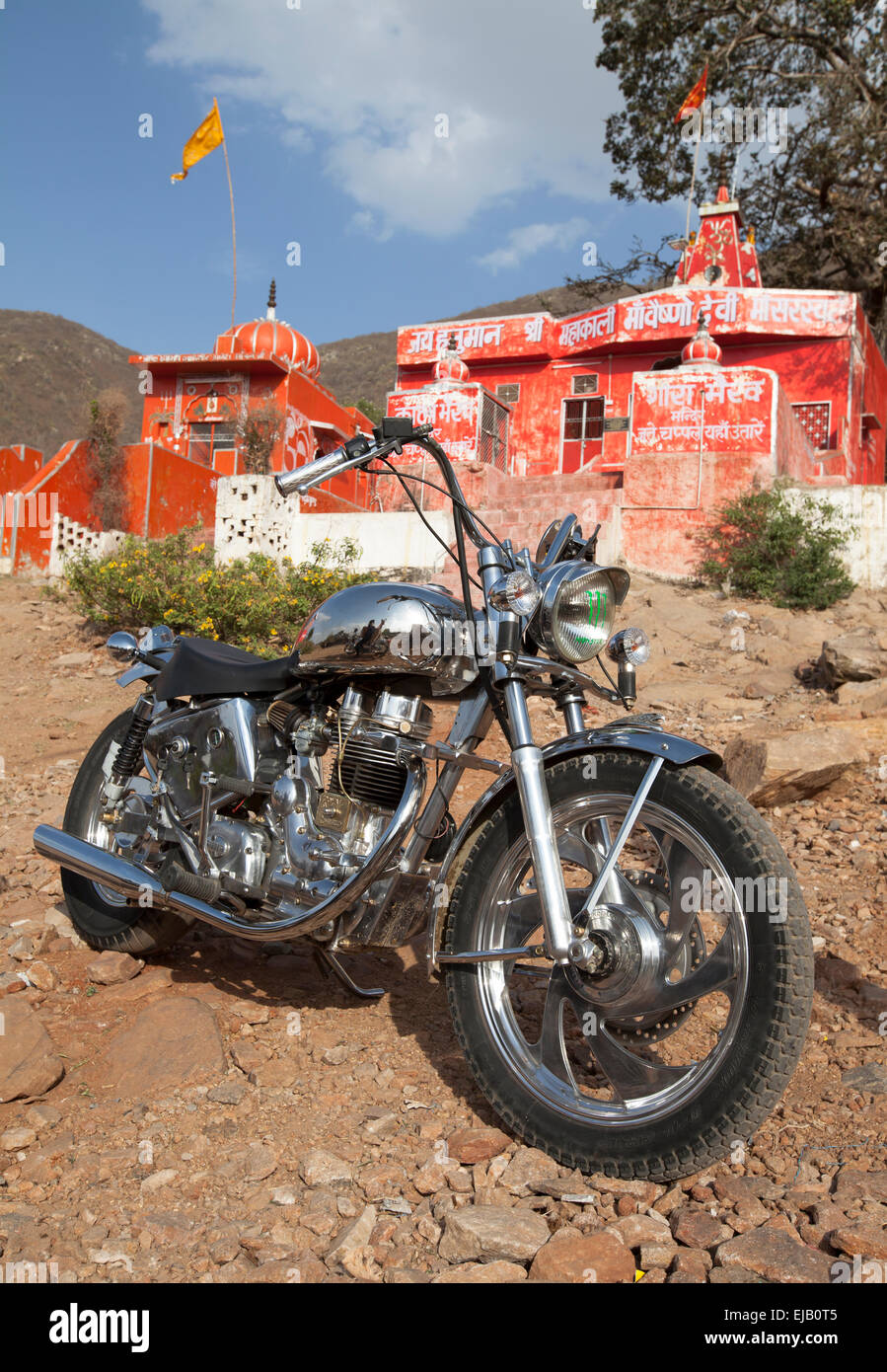 Indian manufactured Royal Enfield motorcycle outside Hindu temple near Pushkar, Rajasthan Stock Photo