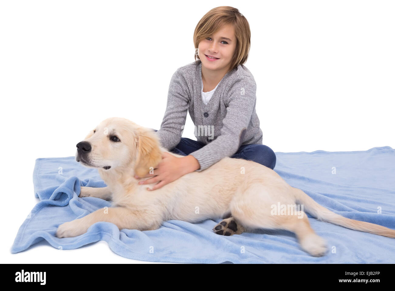 Child rubbing his dog lying on a blanket Stock Photo Alamy