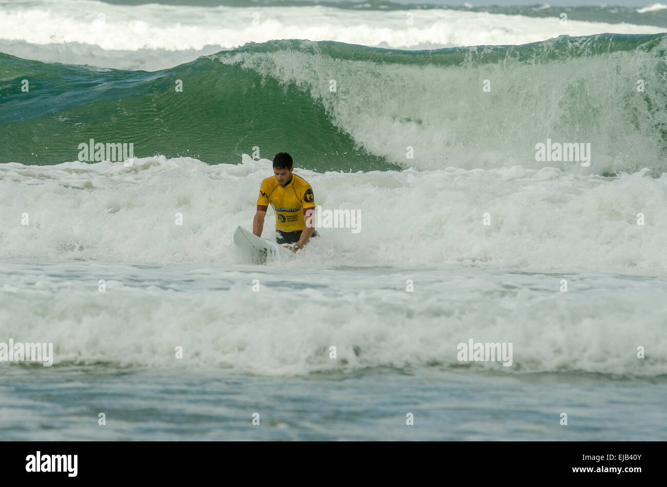 Waves crashing around a pro surfer in the sea at the Boardmasters surf competition Fistral beach Newquay Stock Photo