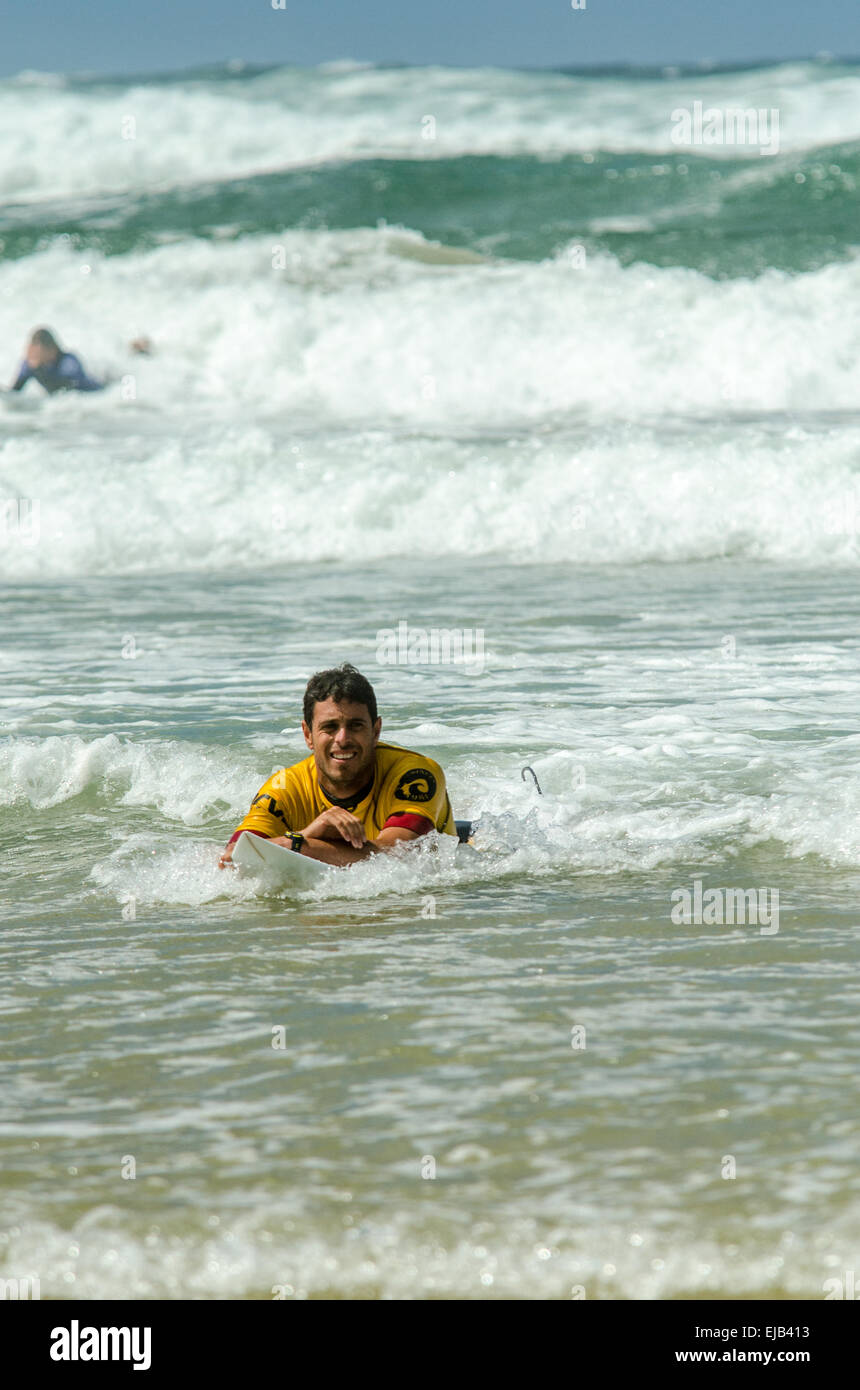 A pro male surfer celebrating in the sea after winning his round of the Boardmasters surf competition at Fistral beach Newquay Stock Photo