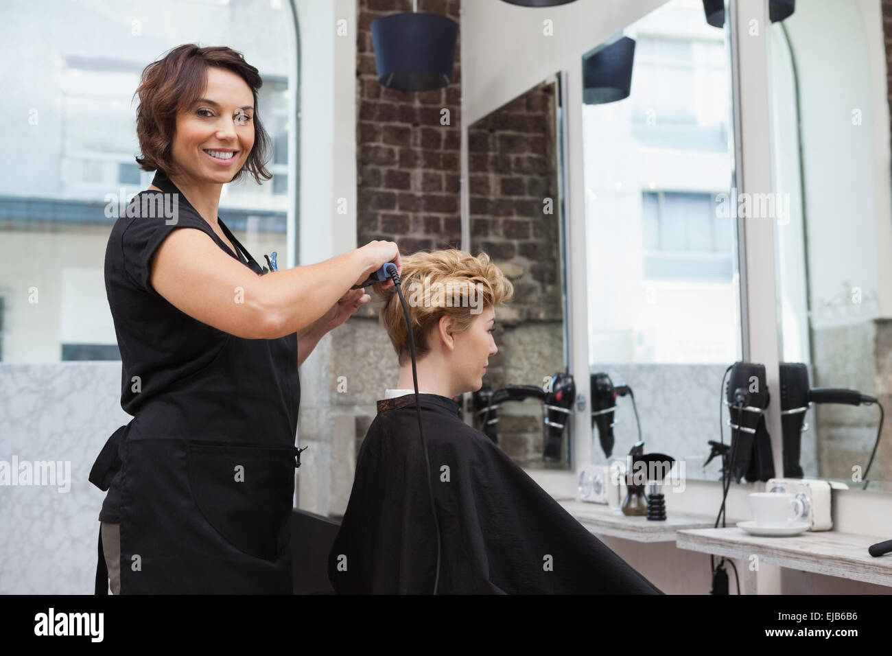 Mature woman drying hair hi-res stock photography and images - Alamy