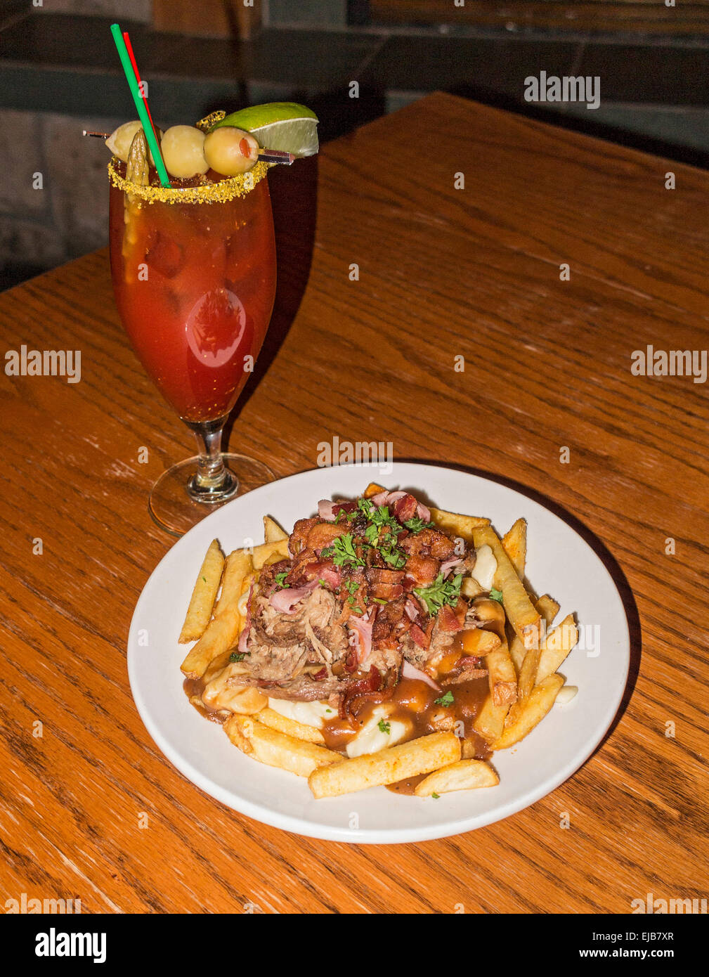 The "Bob Marley," gourmet poutine dish and Bloody Caesar drink served at  Sante Grille, at Big White ski resort Stock Photo - Alamy