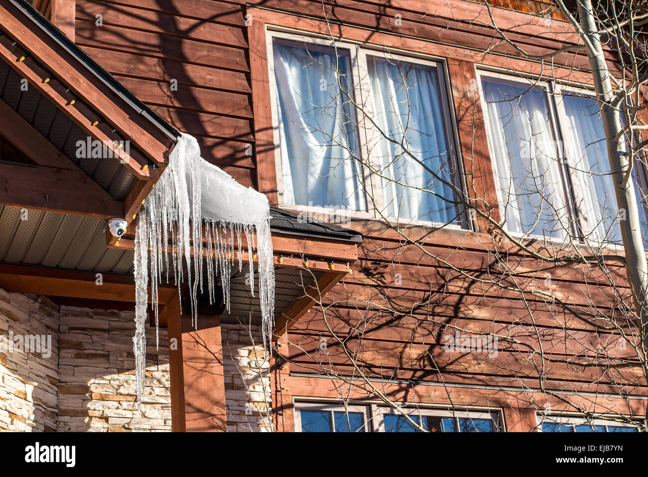 Icicles dripping from a roof in winter. Stock Photo