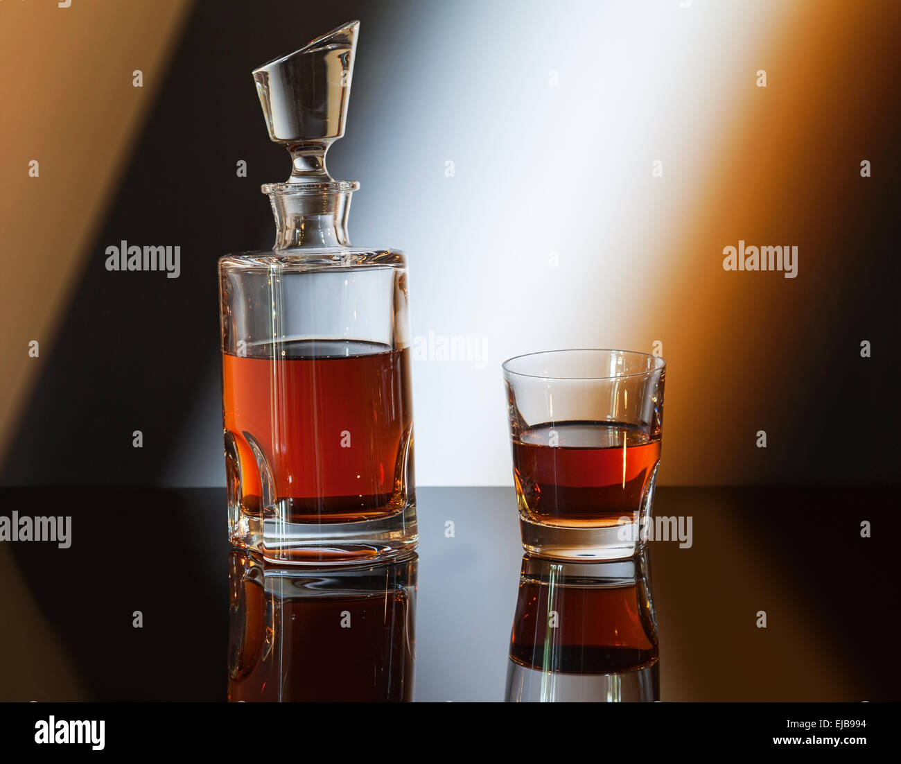 whiskey bottle on abstract background Stock Photo - Alamy