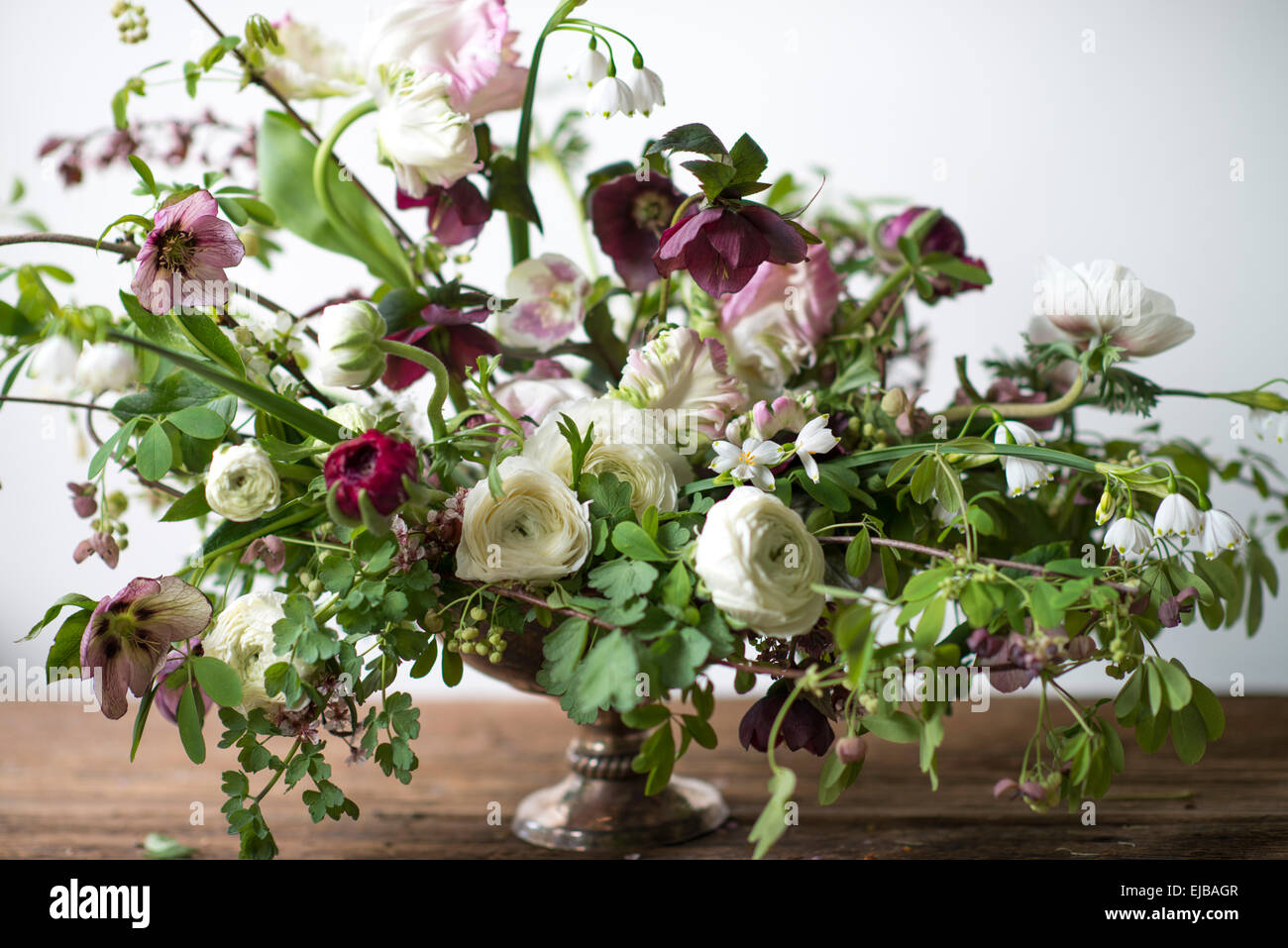 Spring bouquet of parrot tulips, ranunculus, anemones and Lucojum Stock Photo
