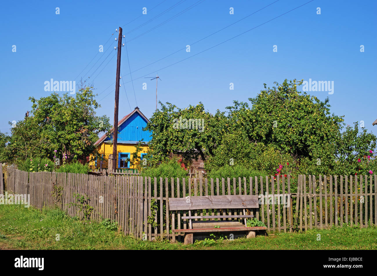Rural landscape - wooden house, wooden fence and bench Stock Photo - Alamy