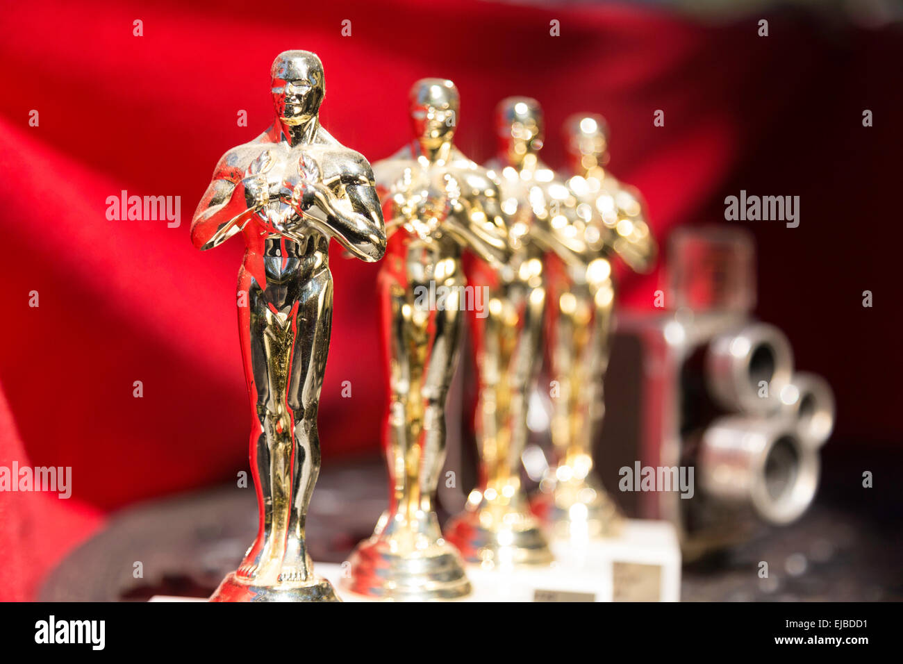 Miniature Oscar Statuettes and Vintage Movie Camera, USA Stock Photo