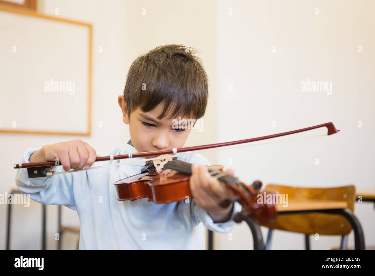 Cute pupil playing violin in classroom Stock Photo - Alamy