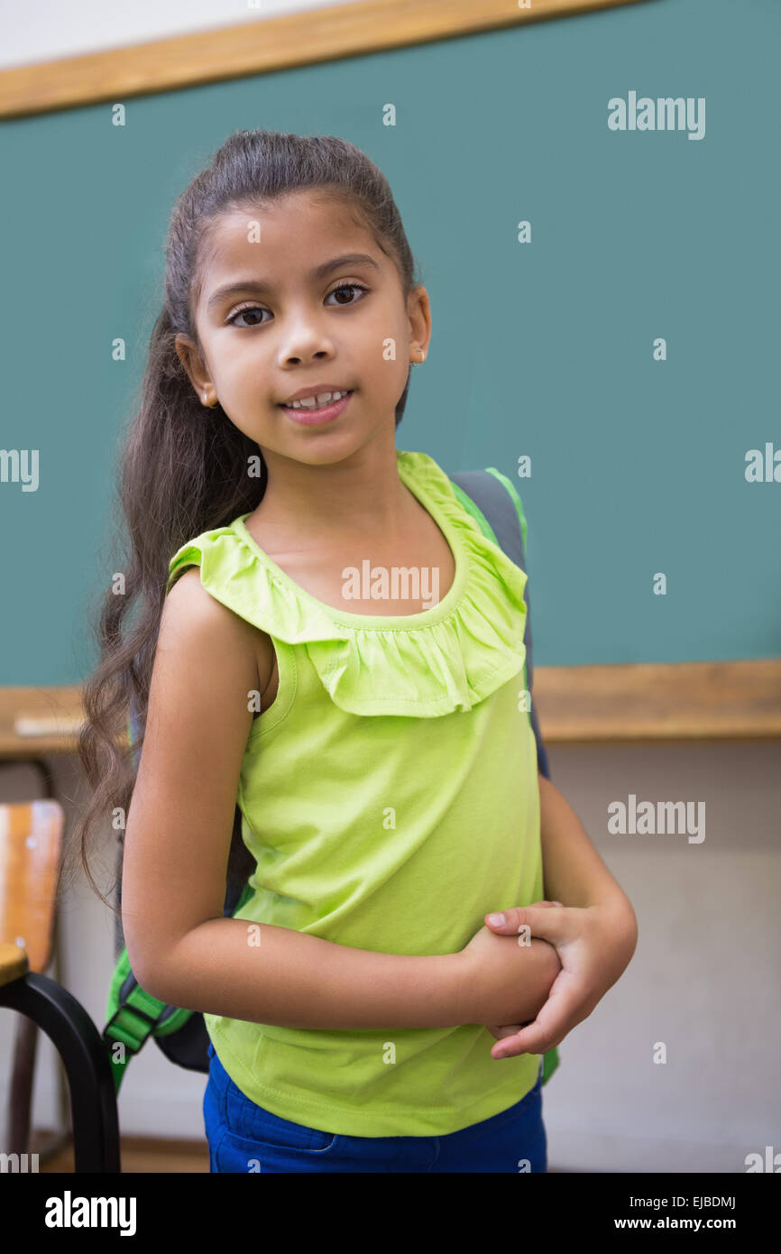 Cute pupil smiling at camera in classroom Stock Photo - Alamy
