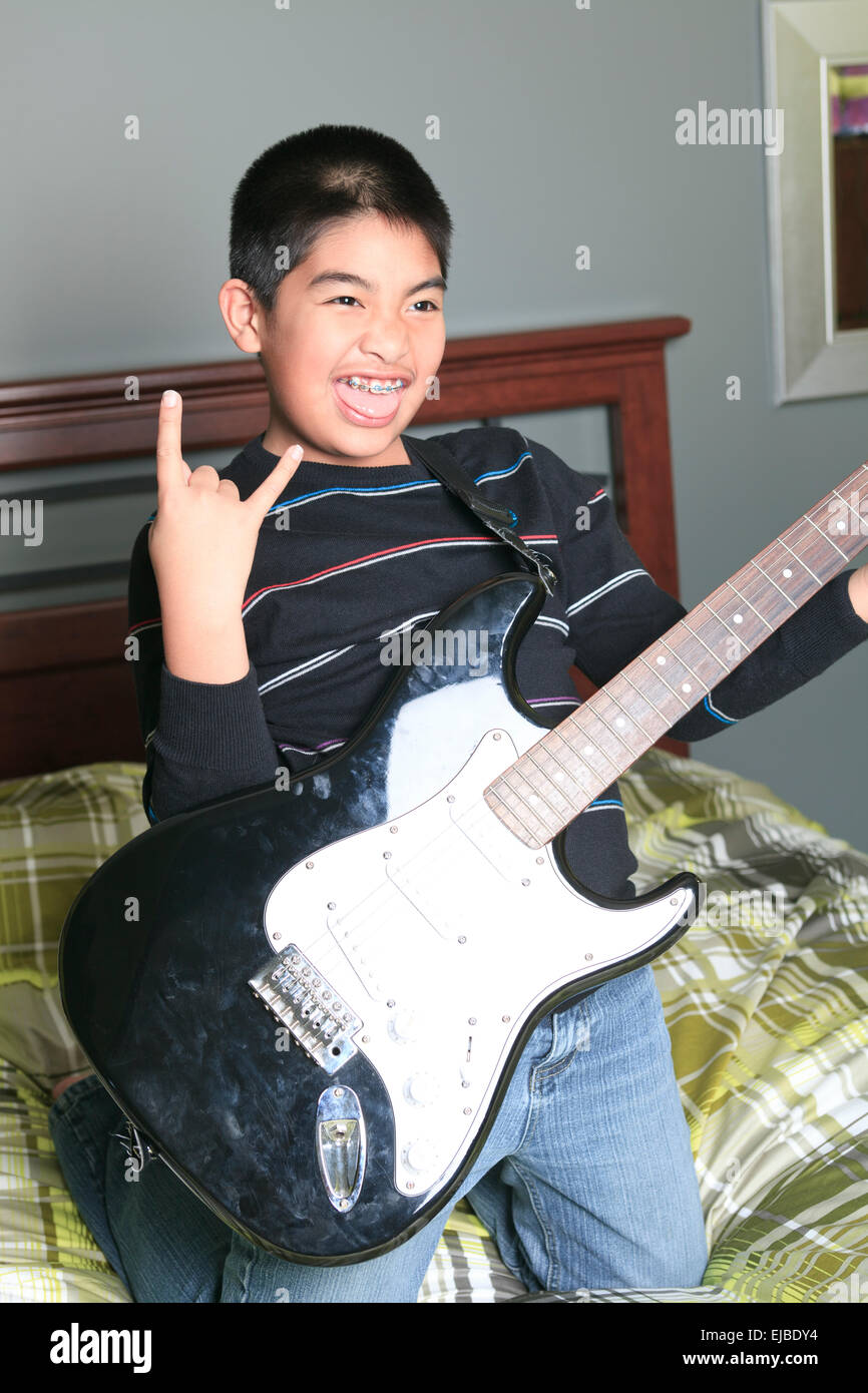 Asian boy play guitar in his bedroom Stock Photo Alamy