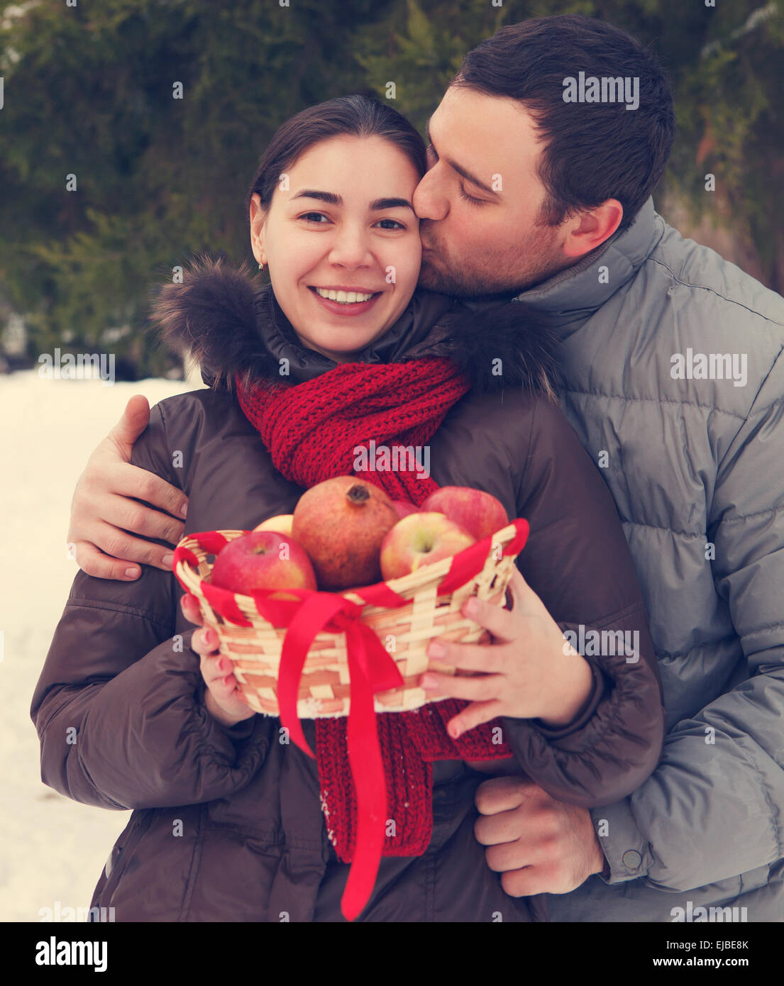 Happy couple having fun in the winter park Stock Photo - Alamy