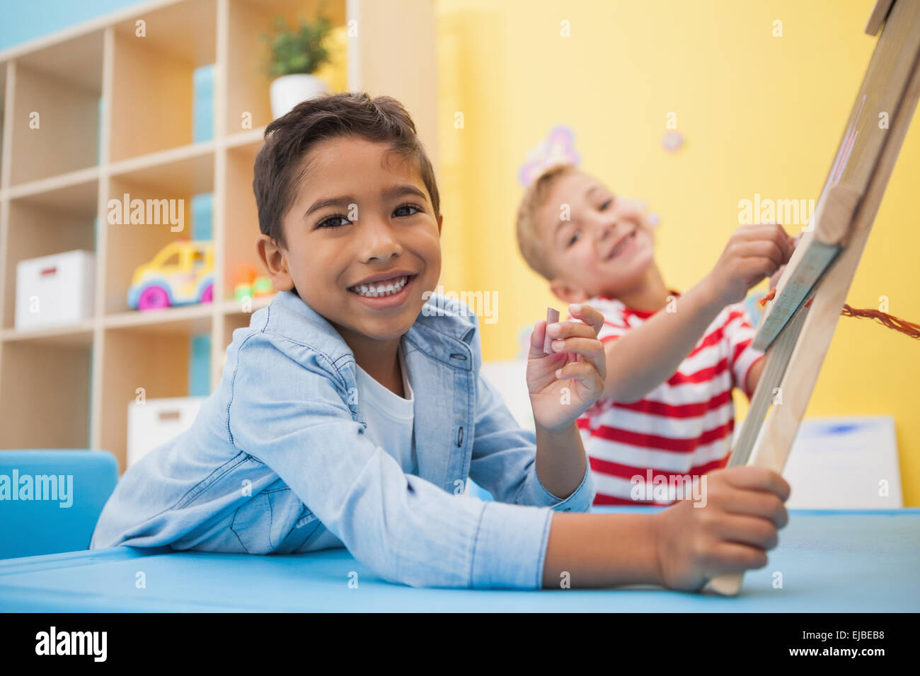 Cute little boys making art in classroom Stock Photo Alamy