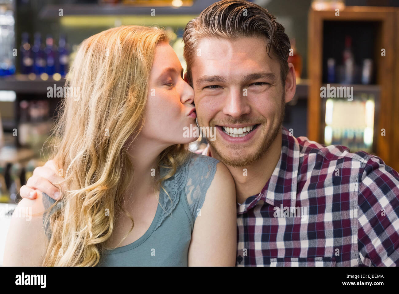 Young couple smiling at the camera Stock Photo - Alamy