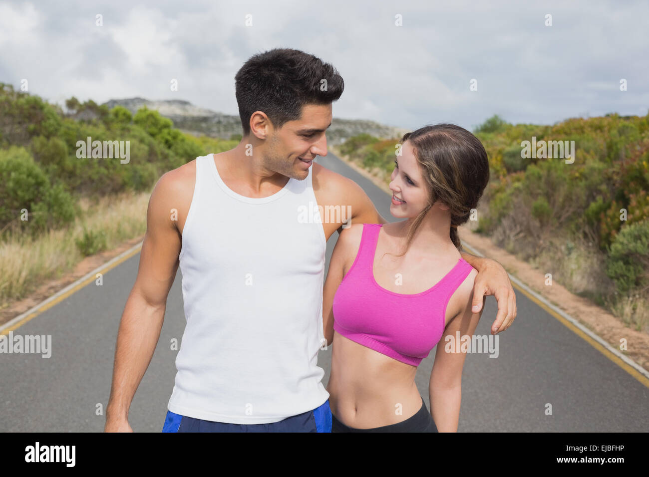 Fit couple standing on the open road Stock Photo