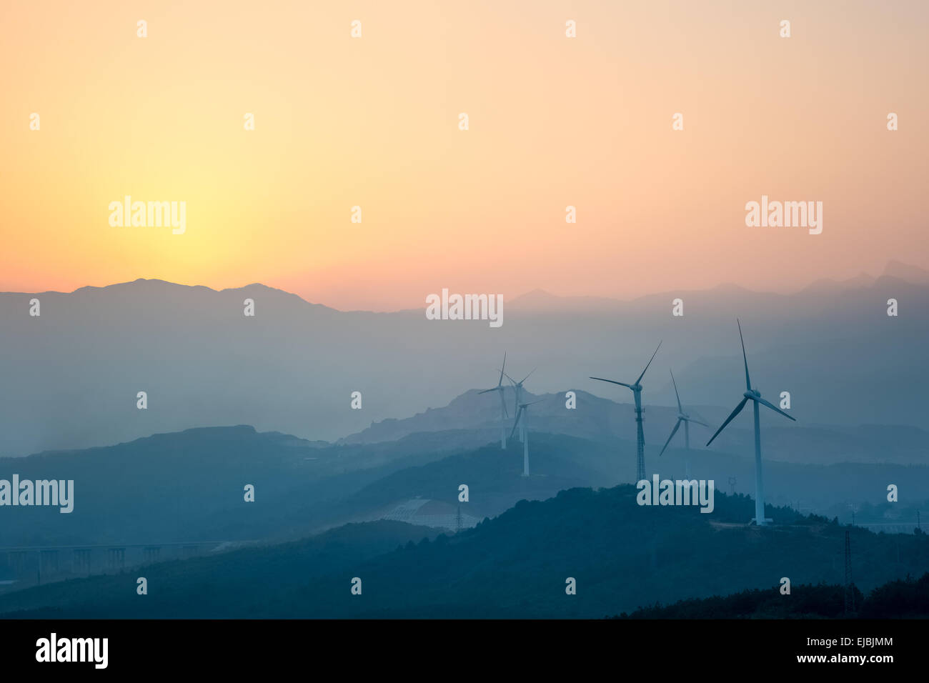 wind farm with distant mountains Stock Photo