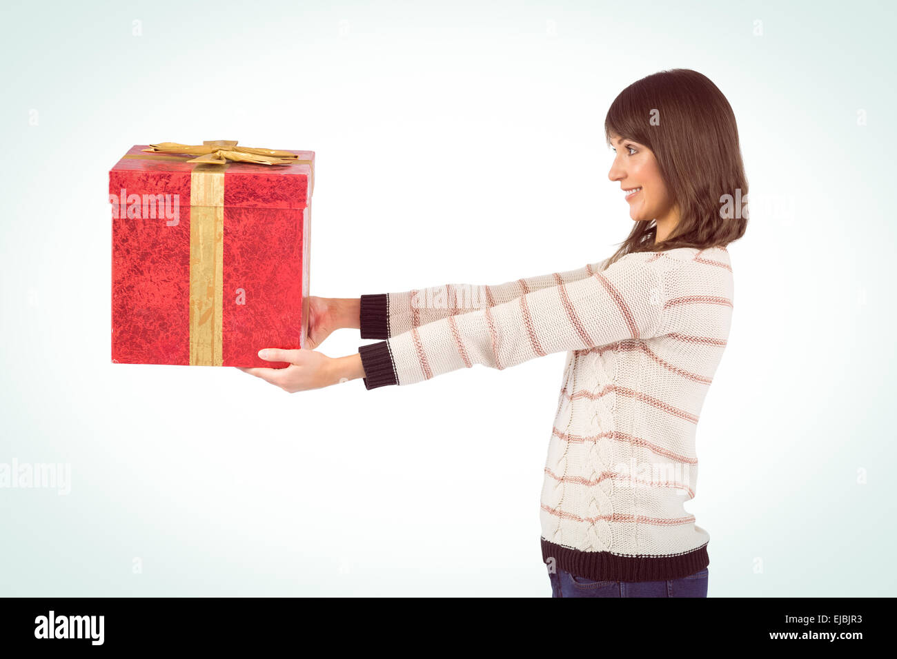 Cute young woman holding a gift Stock Photo - Alamy