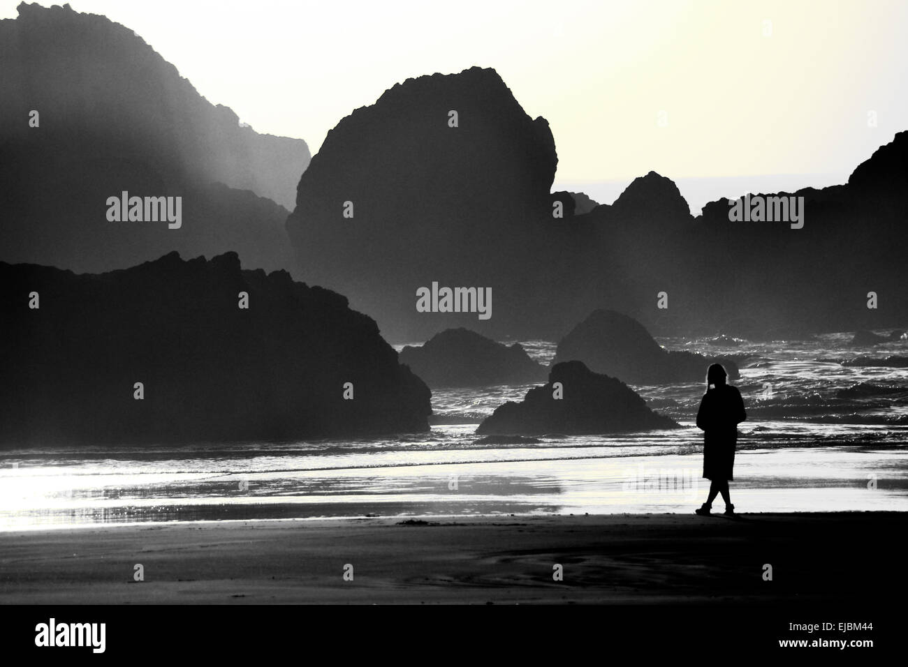 black and white image of a woman standing on a beach Stock Photo - Alamy