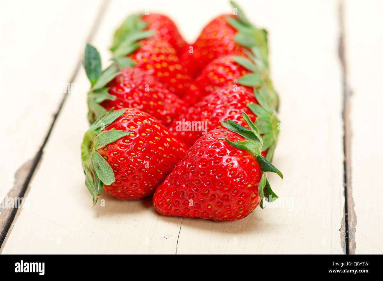 fresh organic strawberry over white wood Stock Photo - Alamy