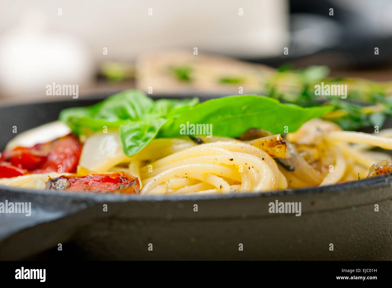 spaghetti pasta with baked cherry tomatoes and basil Stock Photo