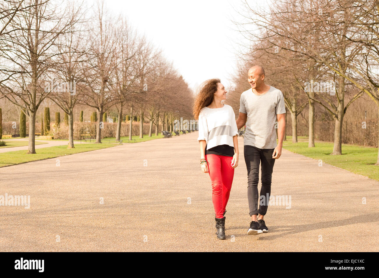 young couple walking in the park Stock Photo - Alamy