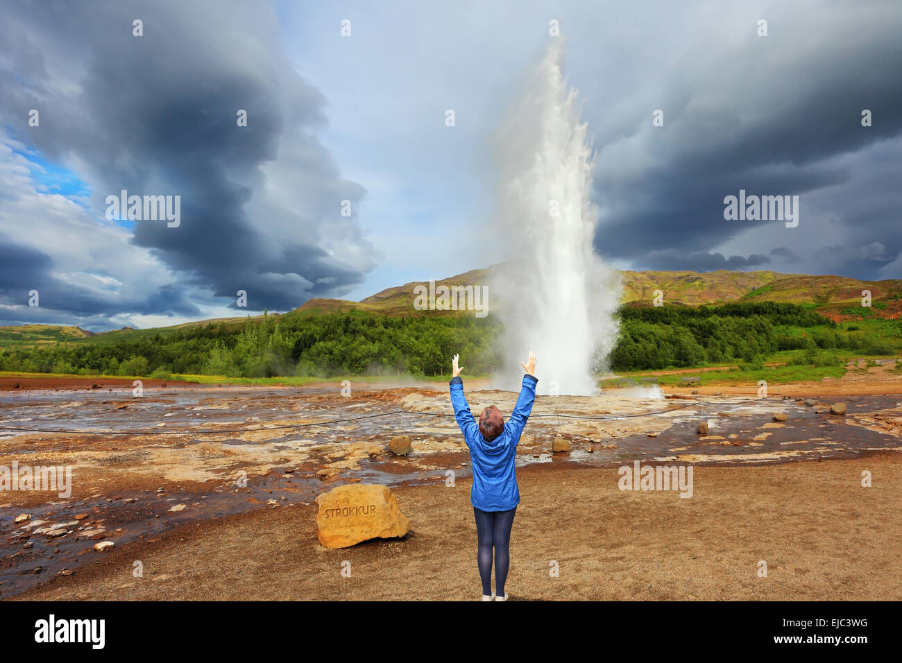 Woman -turist delighted geyser Strokkur Stock Photo